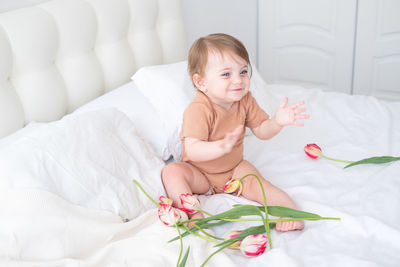 Portrait of cute baby boy sleeping on bed at home