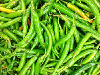 Full frame shot of green chili peppers for sale at market stall