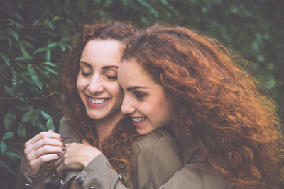 Smiling siblings against plants