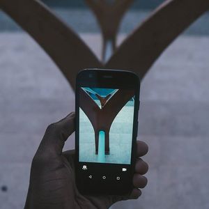 Close-up of hand holding camera