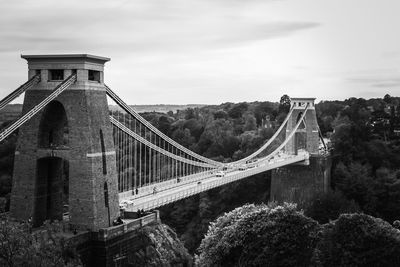 View of suspension bridge against cloudy sky