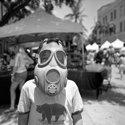 Portrait of boy wearing mask at market