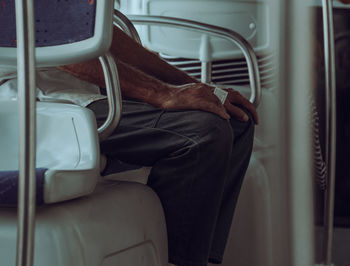 Midsection of man sitting in bus