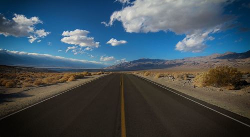 Empty road along countryside landscape