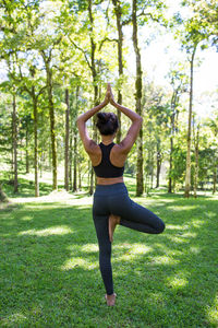 Full length of woman exercising at park