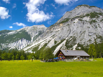 Scenic view of field and mountains against sky