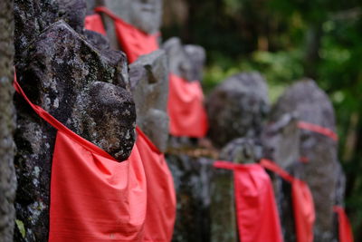 Red fabrics on ksitigarbha bodhisattva stone statues at temple