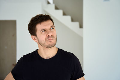 Portrait of young man against wall