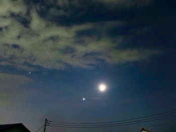 Low angle view of moon at sunset