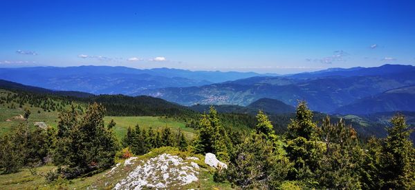 Scenic view of mountains against clear blue sky