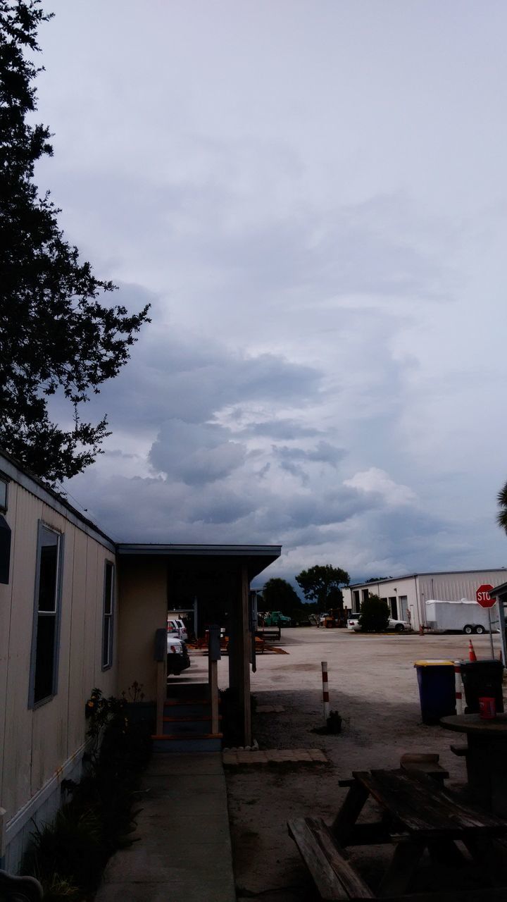 sky, built structure, building exterior, cloud - sky, architecture, weather, the way forward, cloudy, tree, house, transportation, empty, street, overcast, cloud, road, nature, outdoors, day, incidental people