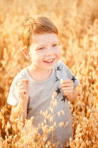 Portrait of smiling boy holding leaf