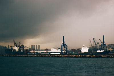 View of harbor against cloudy sky