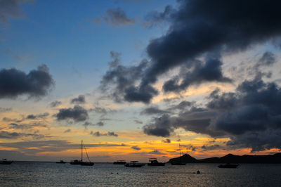 Scenic view of sea against dramatic sky during sunset