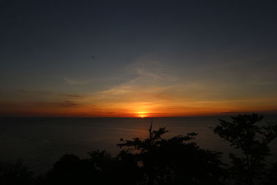 Scenic view of sea against orange sky