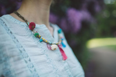 Close-up midsection of woman wearing necklace