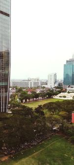 Buildings in city against clear sky