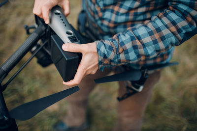 Midsection of man photographing with mobile phone