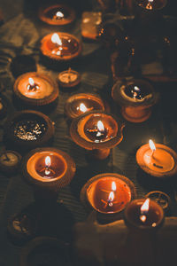 High angle view of lit diyas in temple