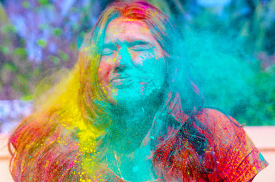 Portrait of man with multi colored face