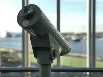 Close-up of coin-operated binoculars against sky