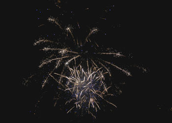 Low angle view of firework display at night