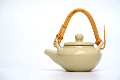 Close-up of tea kettle against blue background