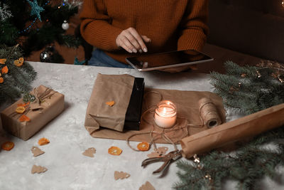 Midsection of woman holding christmas tree