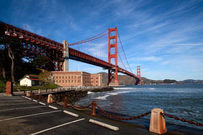 Suspension bridge over sea against sky