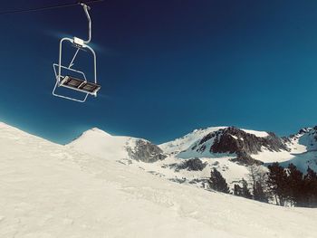 Scenic view of snowcapped mountains against clear blue sky