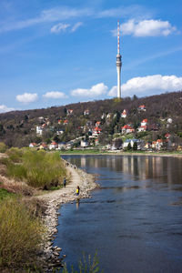 Tower amidst buildings in city against sky