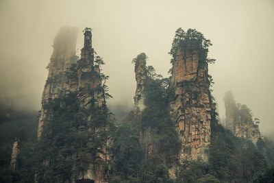 Low angle view of castle on mountain against sky