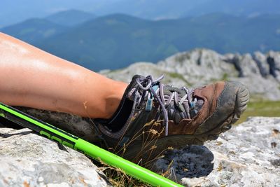 Low section of person on rocky mountain