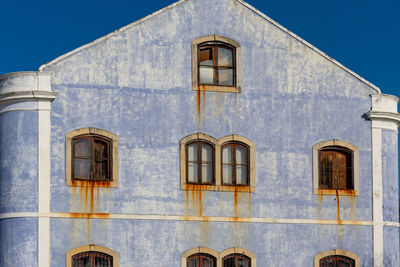 Washed out blue depot facade on the port of lisbon