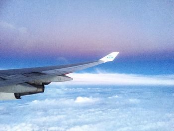 Cropped image of airplane flying over landscape