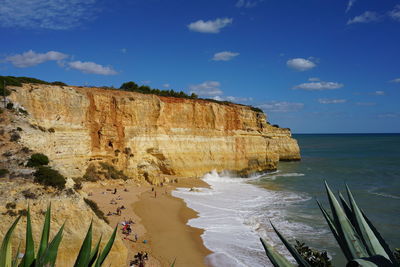 Rock formations by sea against sky