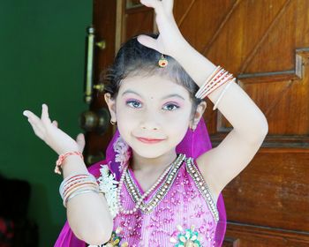 Portrait of girl with arms raised