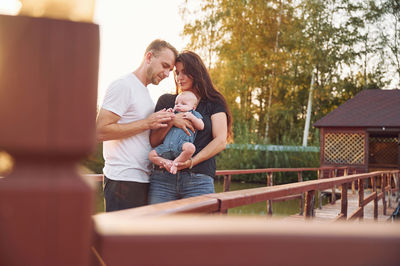 Side view of young woman using mobile phone