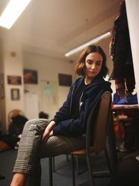 Close-up of young woman sitting on floor