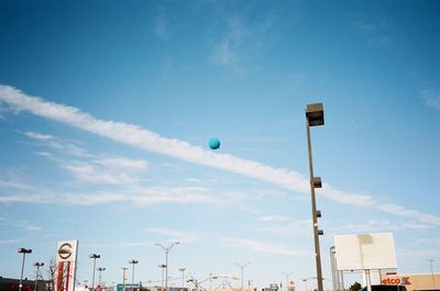 Low angle view of balloons against blue sky