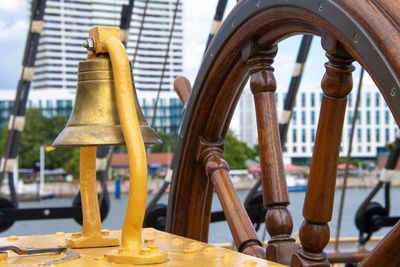 Close-up of sailboat bell and wheel