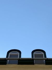 Low angle view of building against clear blue sky