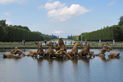 Panoramic view of people on lake against sky
