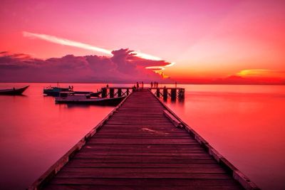 Pier on sea at sunset