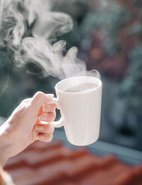 Cropped hand holding coffee