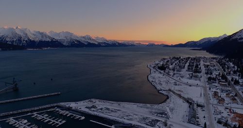 Scenic view of snowcapped mountains against sky during sunset