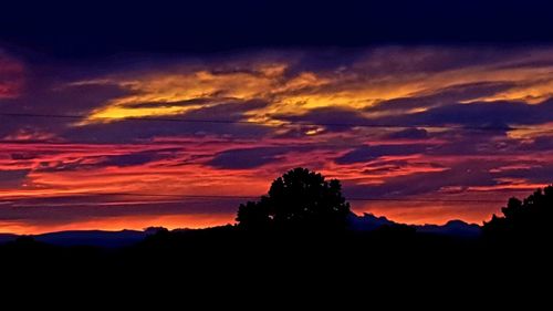 Scenic view of silhouette mountains against sky at sunset