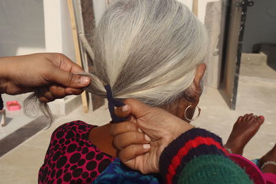 Cropped hand of woman holding hair