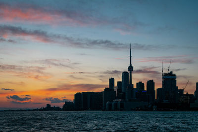 Buildings in city at sunset. 
