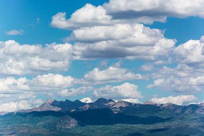 Scenic view of sea and mountains against sky